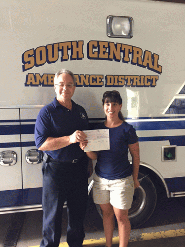 SCAD Chief Koziol accepts a donation from Mini Tri Committee member Joy Weimer. Chief Koziol also accepted donations for Morgan and Rome Fire Departments who were out on call. 